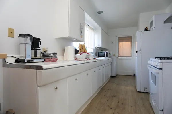 a kitchen with sink a refrigerator and cabinets