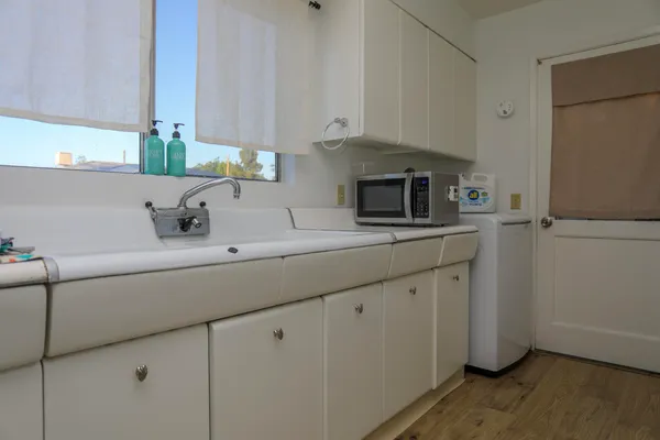 a kitchen with stainless steel appliances granite countertop a sink and a microwave