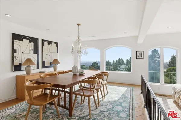 a view of a dining room with furniture window and wooden floor