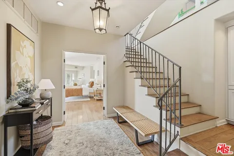a view of entryway dining room and hall with wooden floor