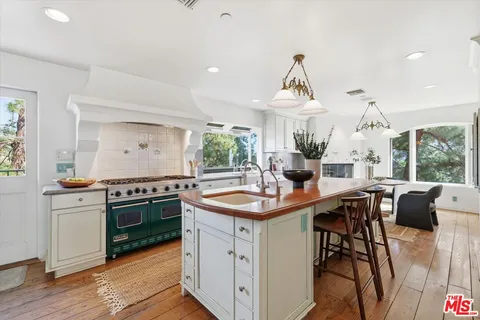 a kitchen with stainless steel appliances granite countertop a sink and stove