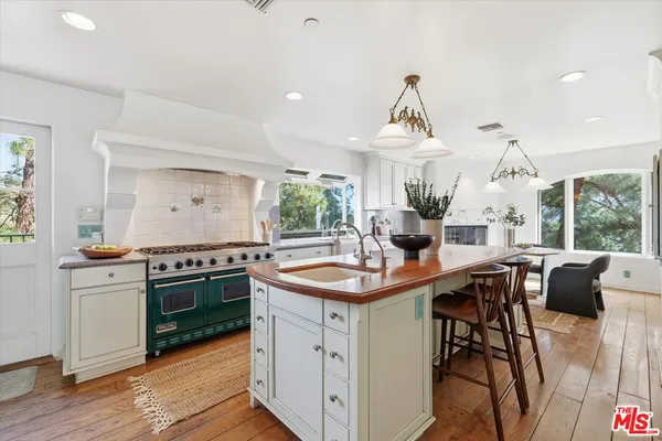 a kitchen with stainless steel appliances granite countertop a sink and stove