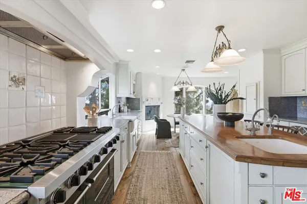 a kitchen with stove and cabinets
