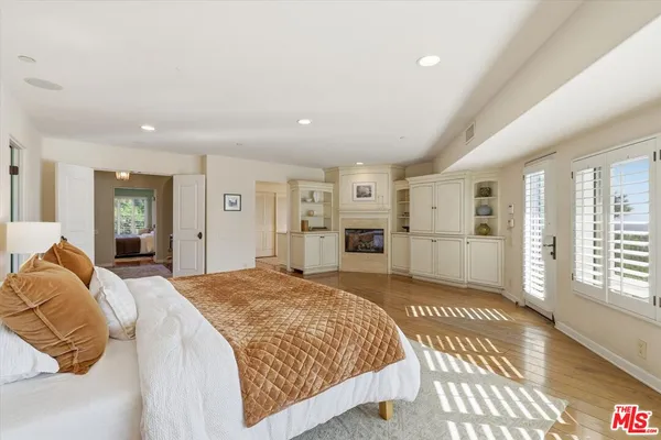 a spacious bedroom with a large bed a walk in closet and a couch