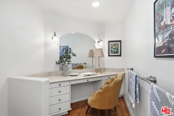 a dining room with table chairs and wooden floor
