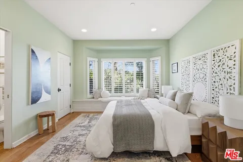 a bed room with a bed and a book shelf