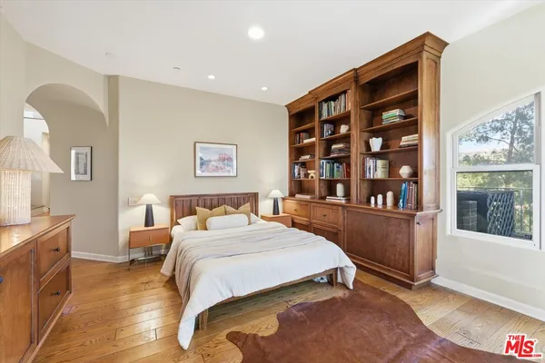 a bedroom with a bed and a large window