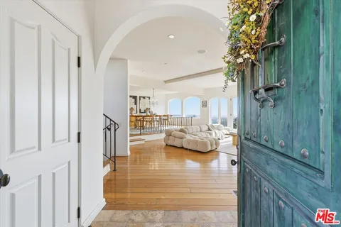 a view of living room with furniture and a large window