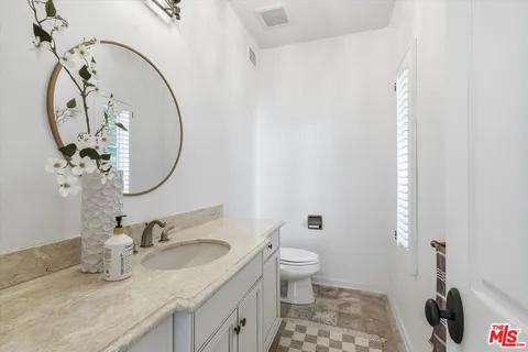 a view of a houses with a lush green forest
