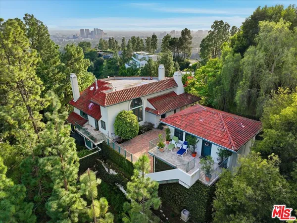 an aerial view of a house with yard and outdoor seating