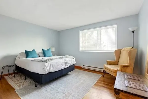 a spacious bedroom with a bed and window