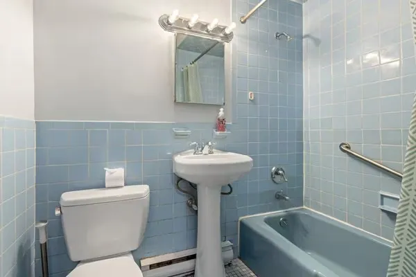 a bathroom with a sink a toilet and bathtub