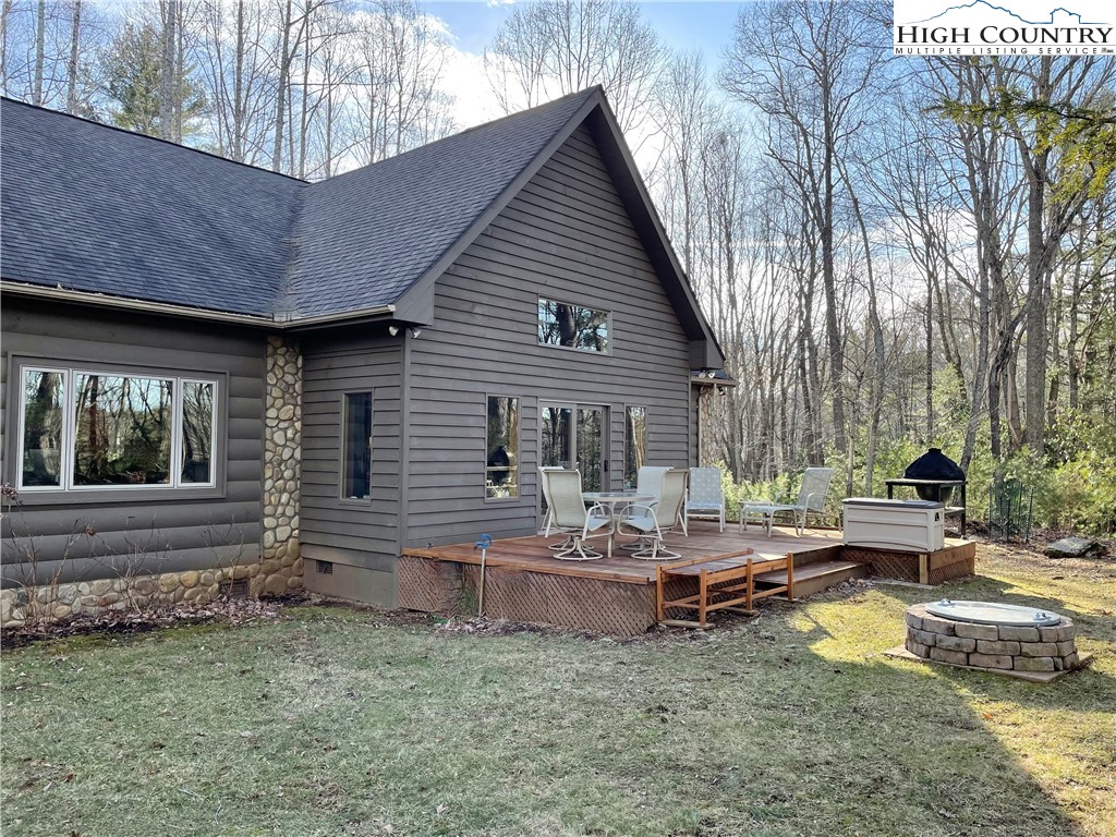 541 Woodland Ridge Lansing, NC 28643 - Photo 11 of 45 a view of house with backyard and seating area