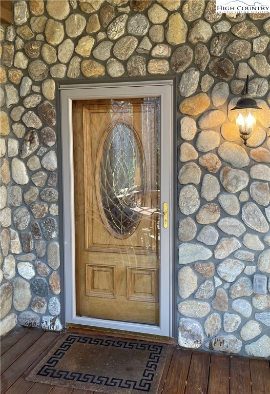 541 Woodland Ridge Lansing, NC 28643 - Photo 16 of 45 a view of a wooden door with a bench in front of door