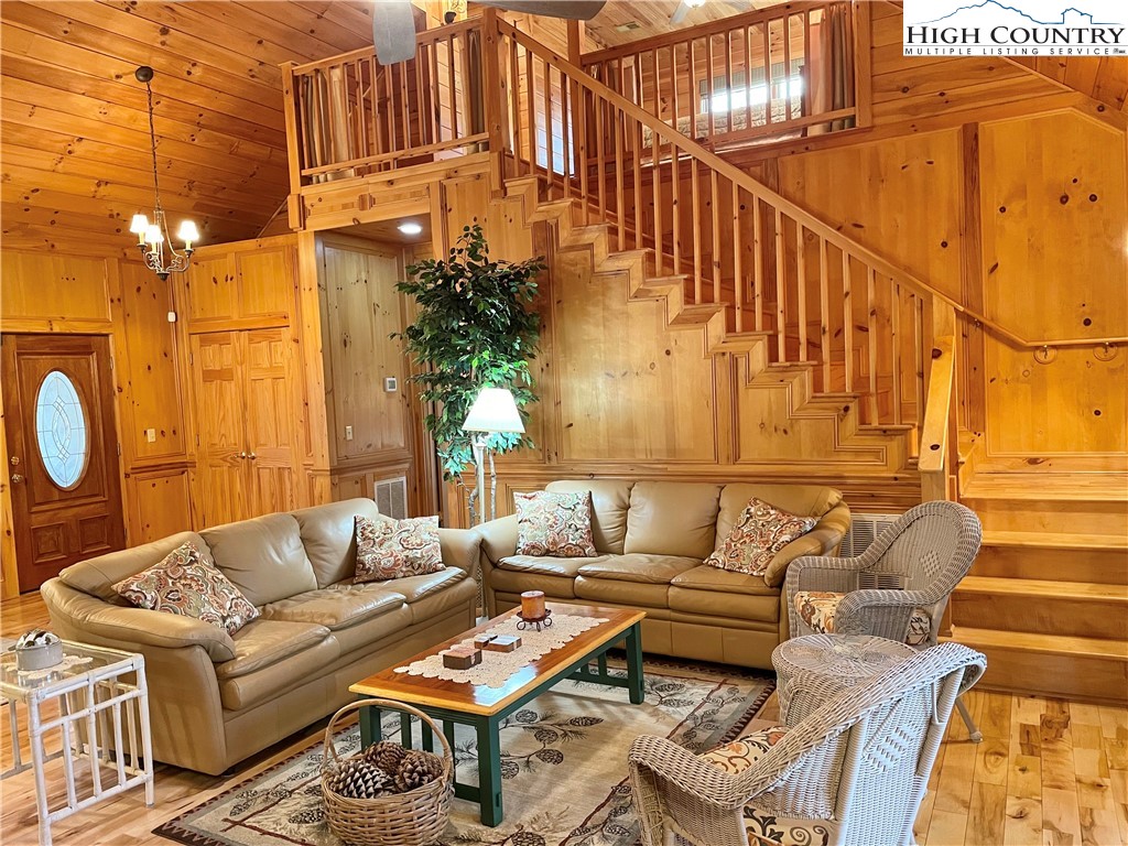 541 Woodland Ridge Lansing, NC 28643 - Photo 19 of 45 a living room with couches a fireplace with wooden floor