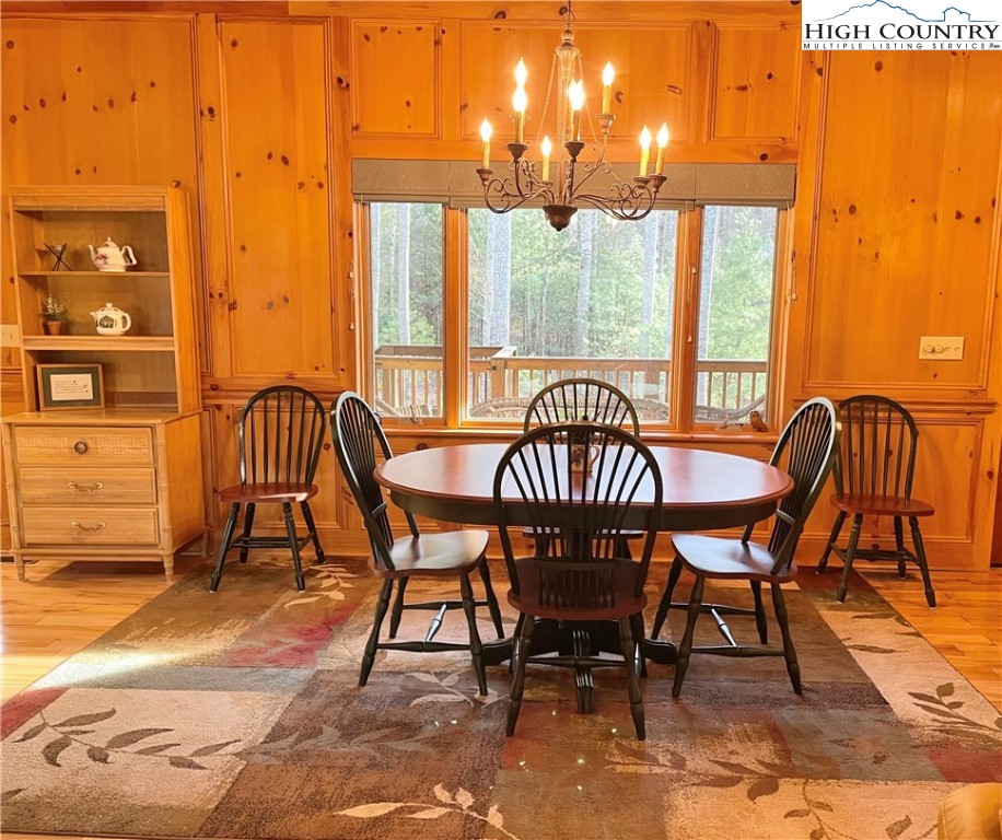 541 Woodland Ridge Lansing, NC 28643 - Photo 23 of 45 a view of a dining room with furniture and a floor to ceiling window