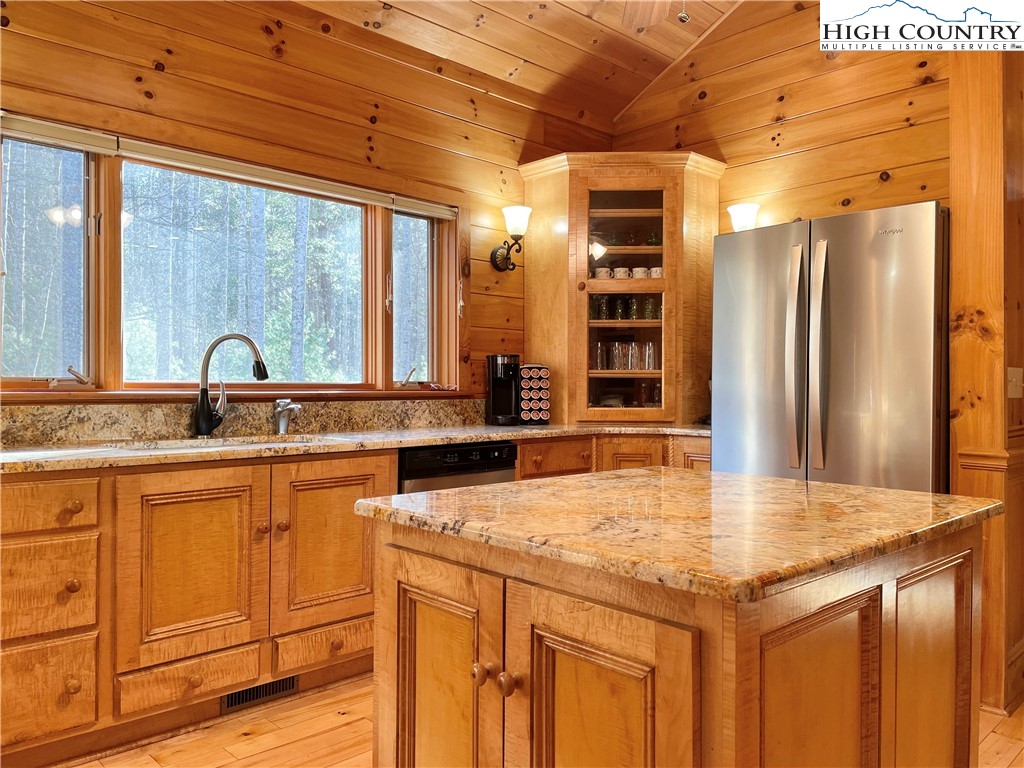 541 Woodland Ridge Lansing, NC 28643 - Photo 24 of 45 a kitchen with stainless steel appliances granite countertop a sink and cabinets