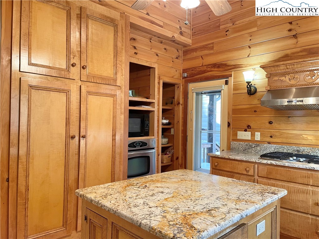 541 Woodland Ridge Lansing, NC 28643 - Photo 25 of 45 a kitchen with kitchen island granite countertop cabinets and refrigerator