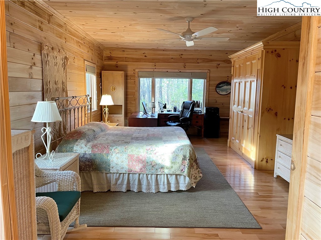 541 Woodland Ridge Lansing, NC 28643 - Photo 30 of 45 a spacious bedroom with a bed and wooden floor