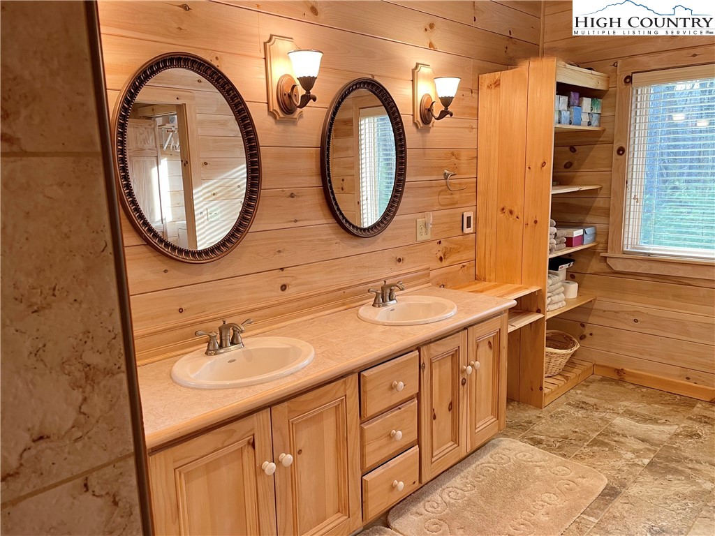 541 Woodland Ridge Lansing, NC 28643 - Photo 32 of 45 a bathroom with a double vanity sink and a mirror