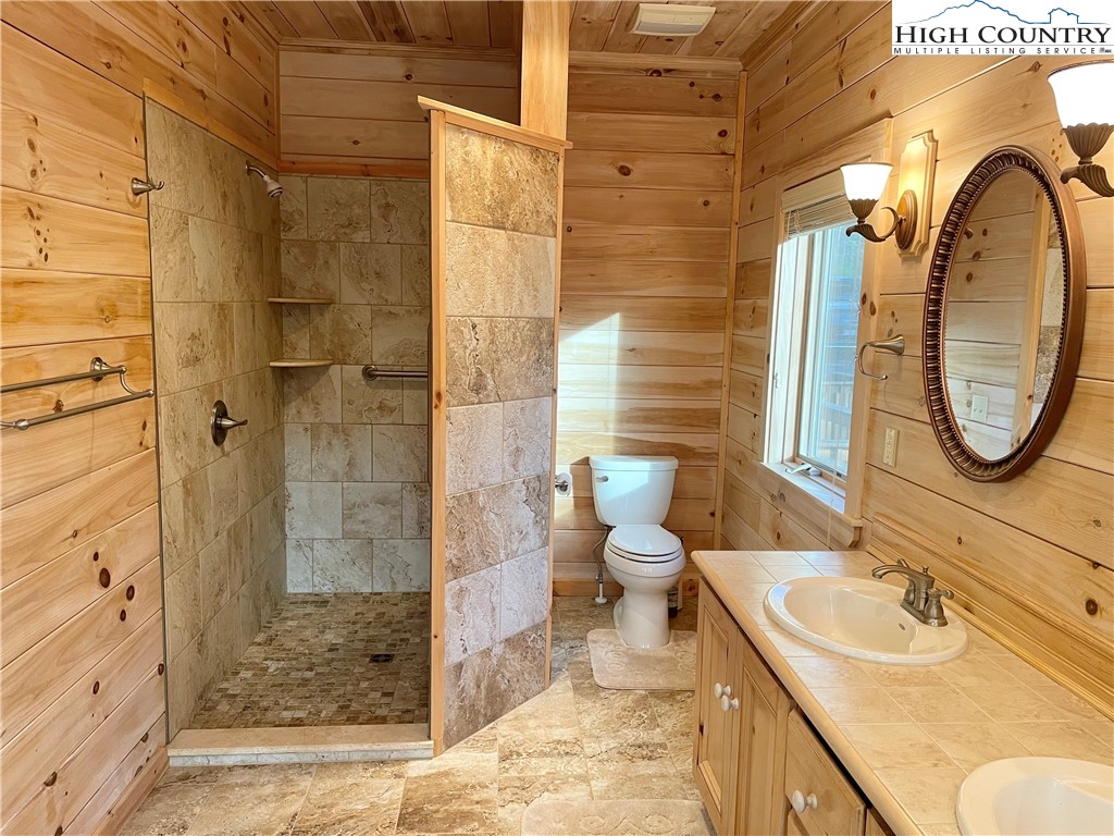 541 Woodland Ridge Lansing, NC 28643 - Photo 33 of 45 a bathroom with a sink toilet and shower
