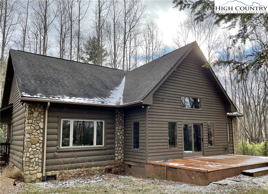 541 Woodland Ridge Lansing, NC 28643 - Photo 8 of 45 a house with trees in the background