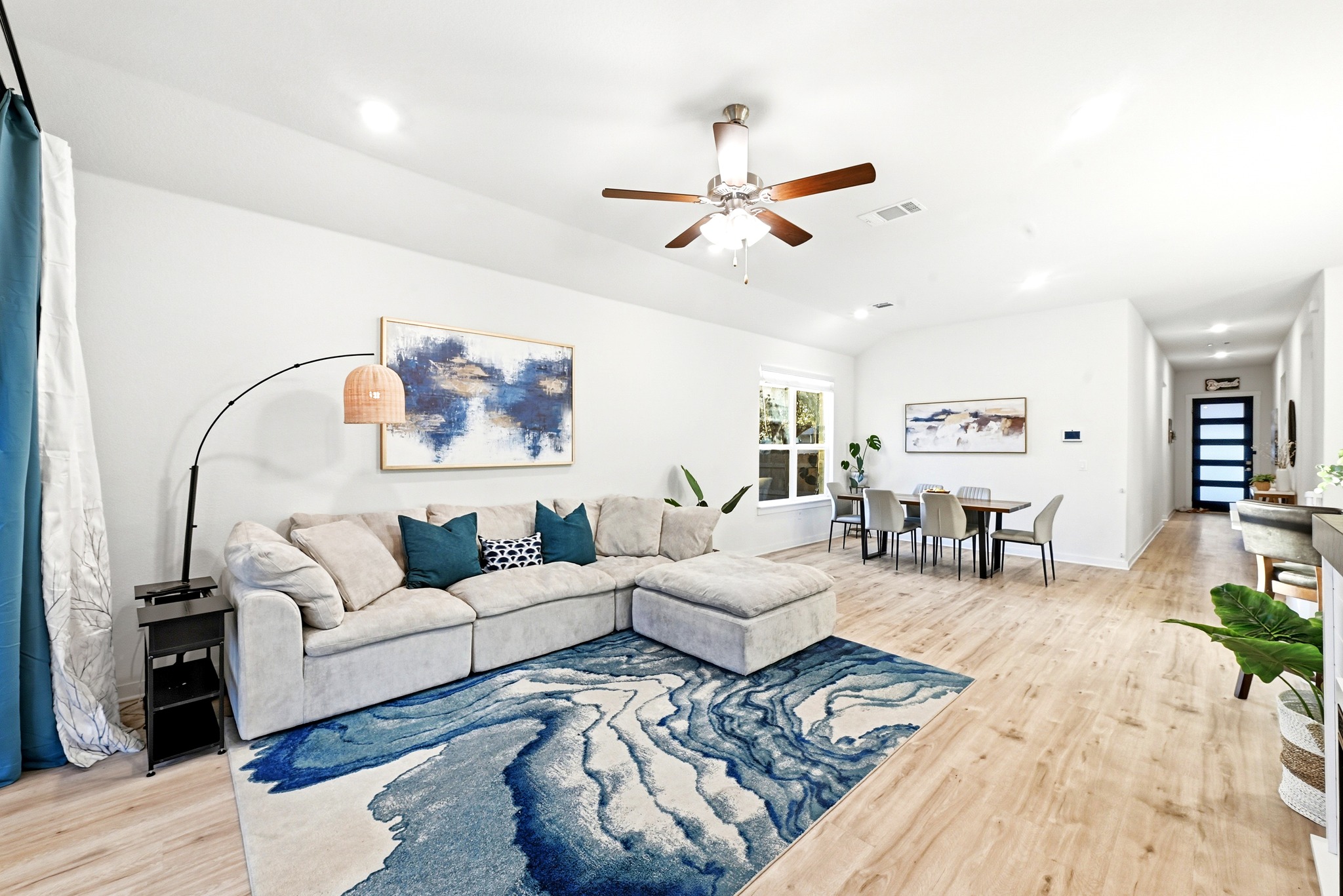 4420 Ingram Road Georgetown, TX 78628 - Photo 15 of 40 An inviting open-concept living area with soaring vaulted ceilings and polished hardwood flooring welcomes all.