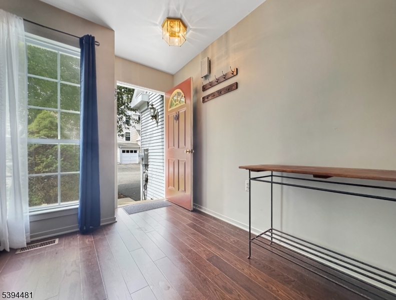 5 Ajax Court Hackettstown, NJ 07840 - Photo 2 of 19 a view of an empty room with a window and wooden floor