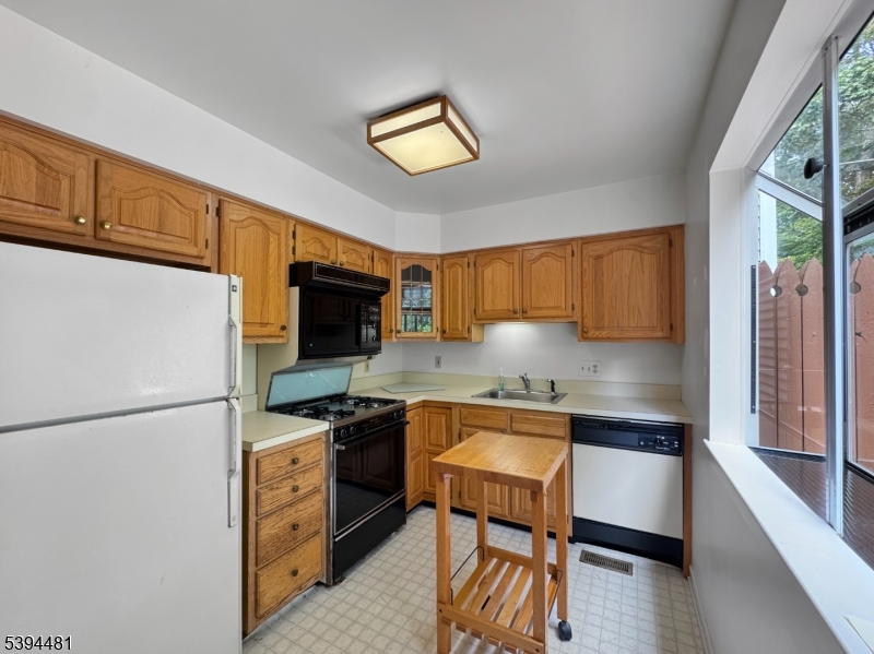 5 Ajax Court Hackettstown, NJ 07840 - Photo 6 of 19 a kitchen with stainless steel appliances granite countertop a refrigerator a stove a sink dishwasher and white cabinets with wooden floor