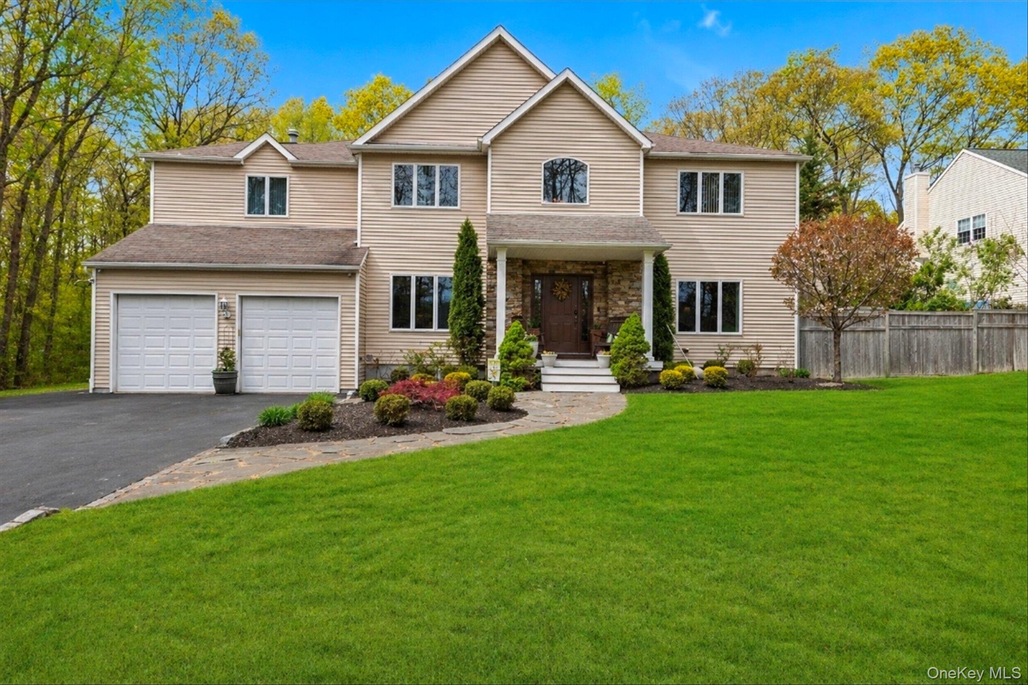 263 Old Commack Road Kings Park, NY 11754 - Photo 1 of 42 a front view of a house with a yard and trees