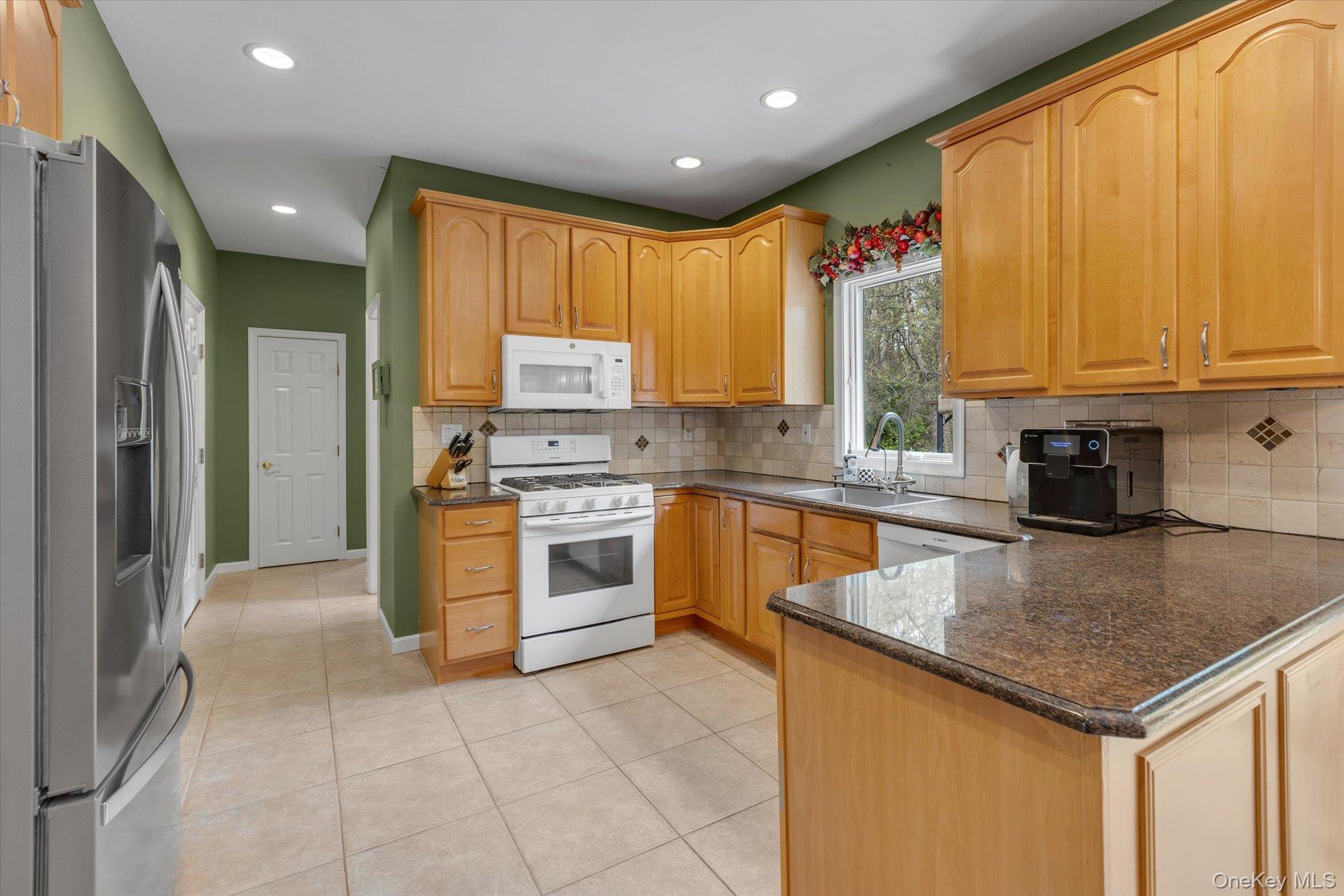 263 Old Commack Road Kings Park, NY 11754 - Photo 11 of 42 a kitchen with stainless steel appliances granite countertop a stove a sink and a refrigerator
