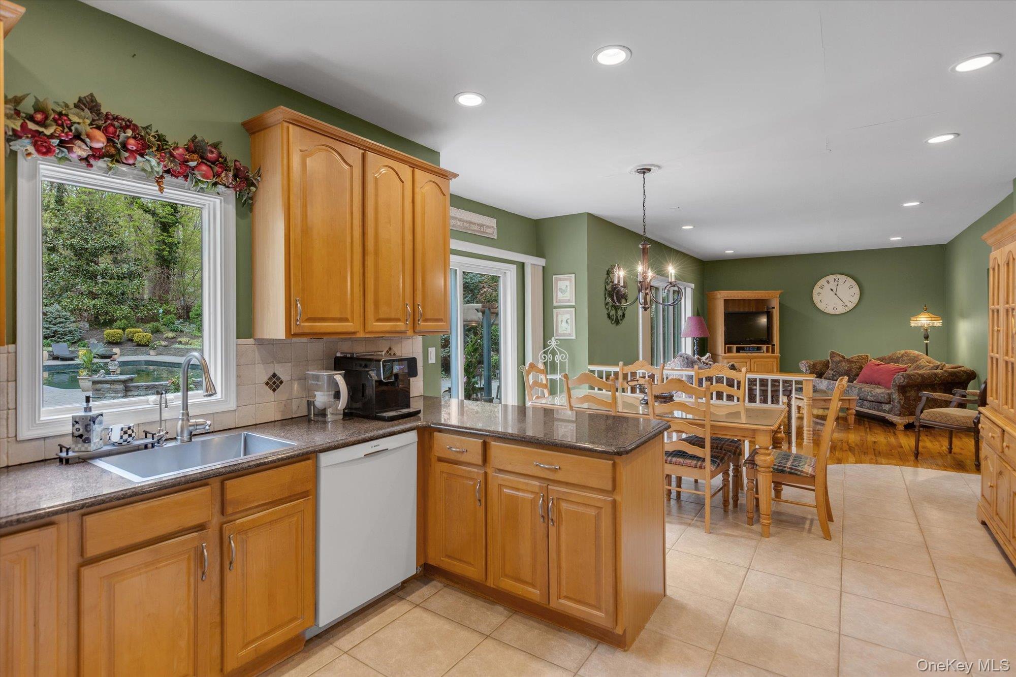 263 Old Commack Road Kings Park, NY 11754 - Photo 12 of 42 a large kitchen with kitchen island a large window in it