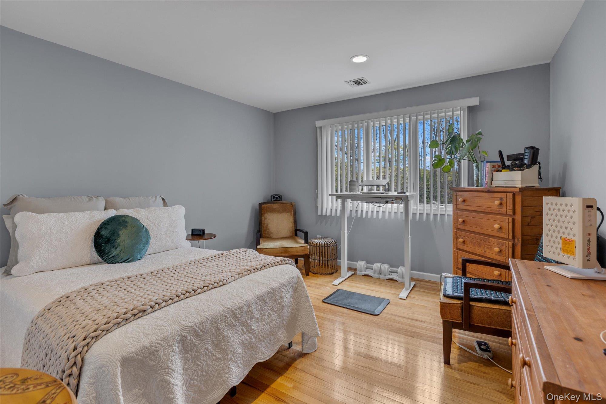 263 Old Commack Road Kings Park, NY 11754 - Photo 18 of 42 a bedroom with a bed furniture computer on table and a large window