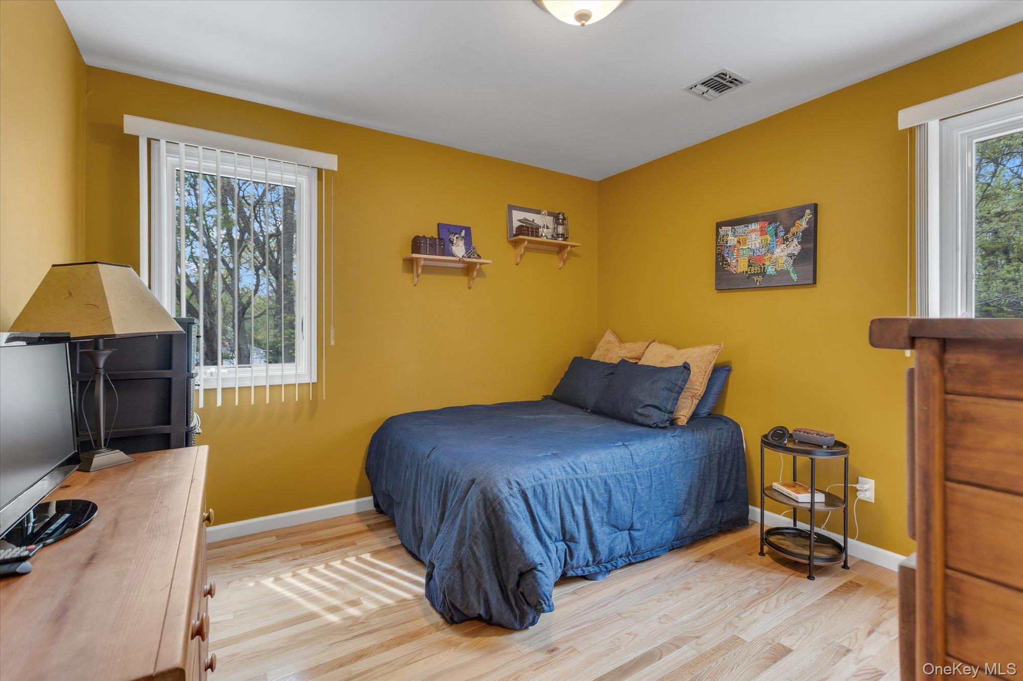 263 Old Commack Road Kings Park, NY 11754 - Photo 20 of 42 a bedroom with a bed and wooden floor