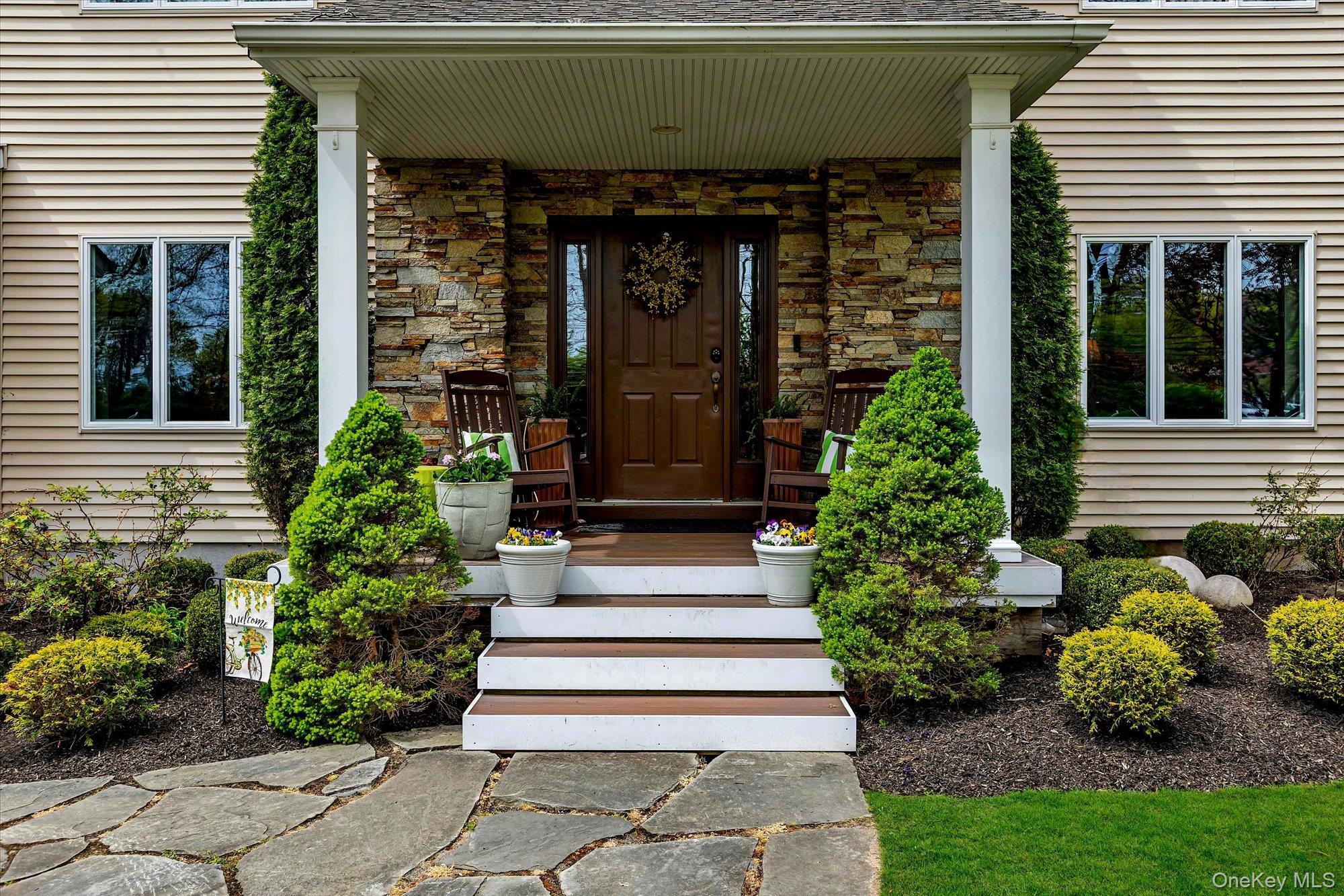 263 Old Commack Road Kings Park, NY 11754 - Photo 2 of 42 a front view of a house with a garden