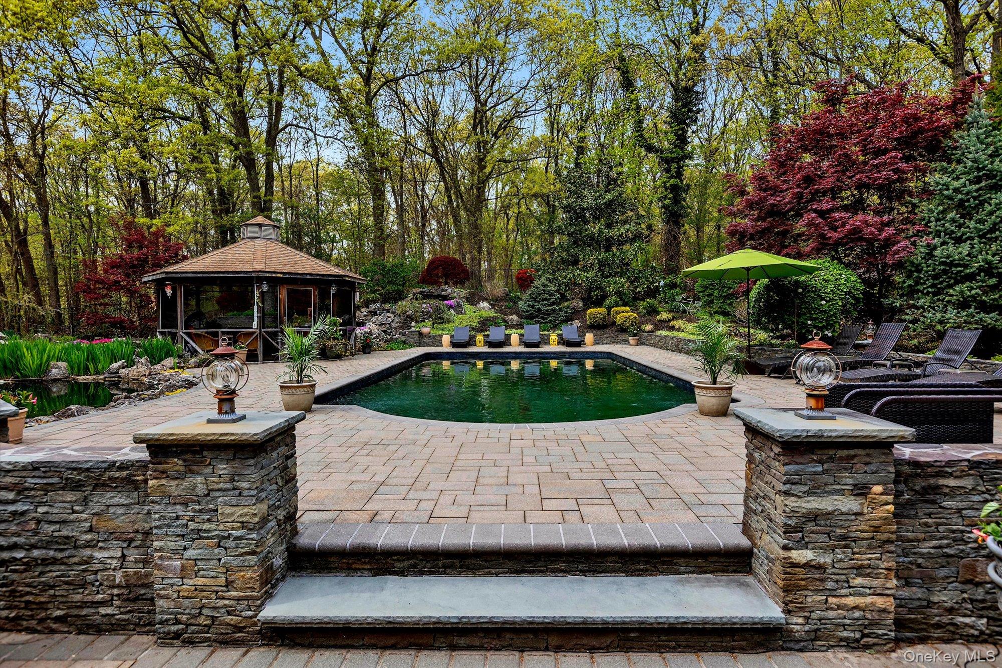 263 Old Commack Road Kings Park, NY 11754 - Photo 25 of 42 a view of a patio with table and chairs under an umbrella