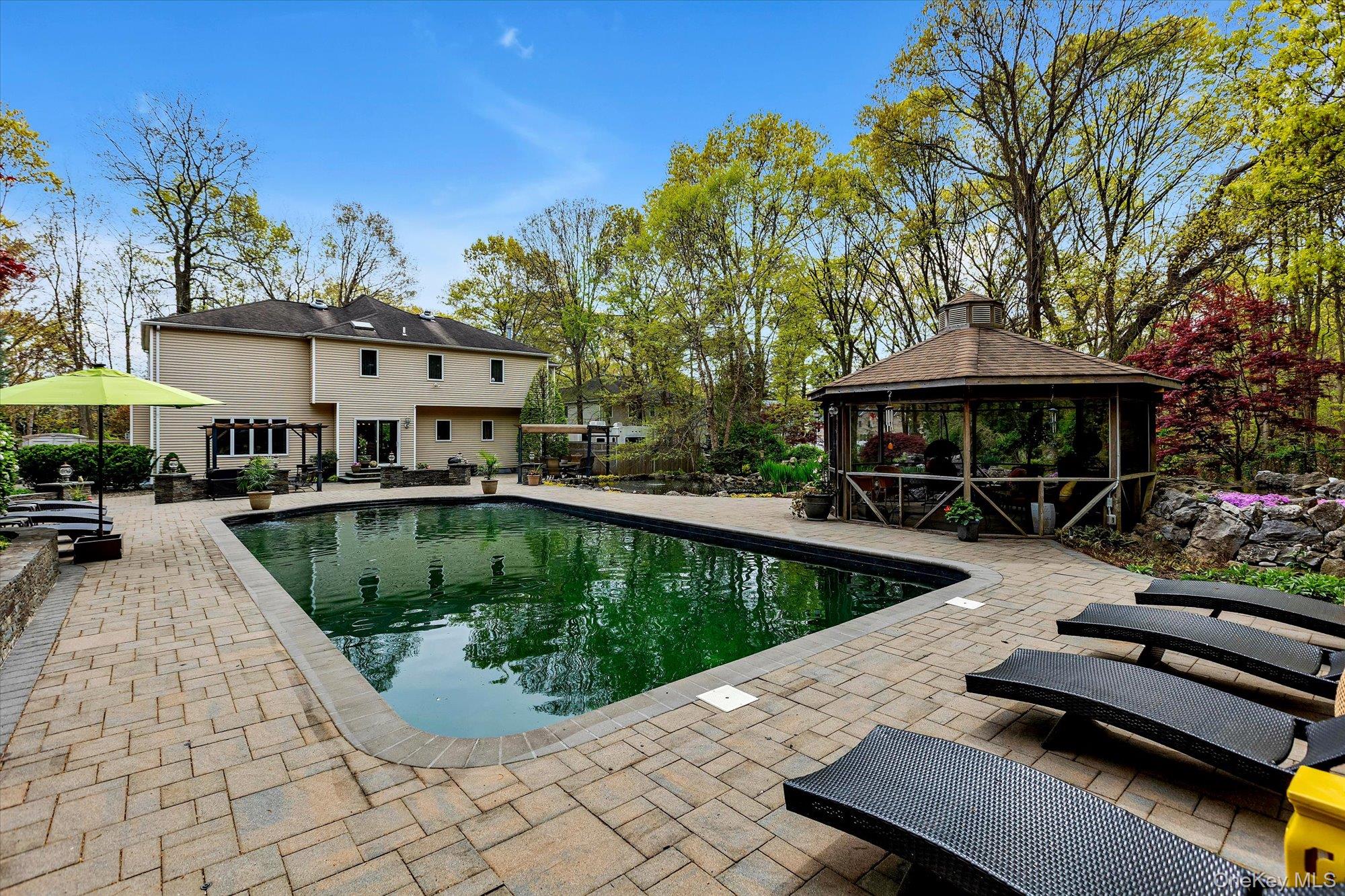 263 Old Commack Road Kings Park, NY 11754 - Photo 27 of 42 a view of a swimming pool with lounge chairs in patio
