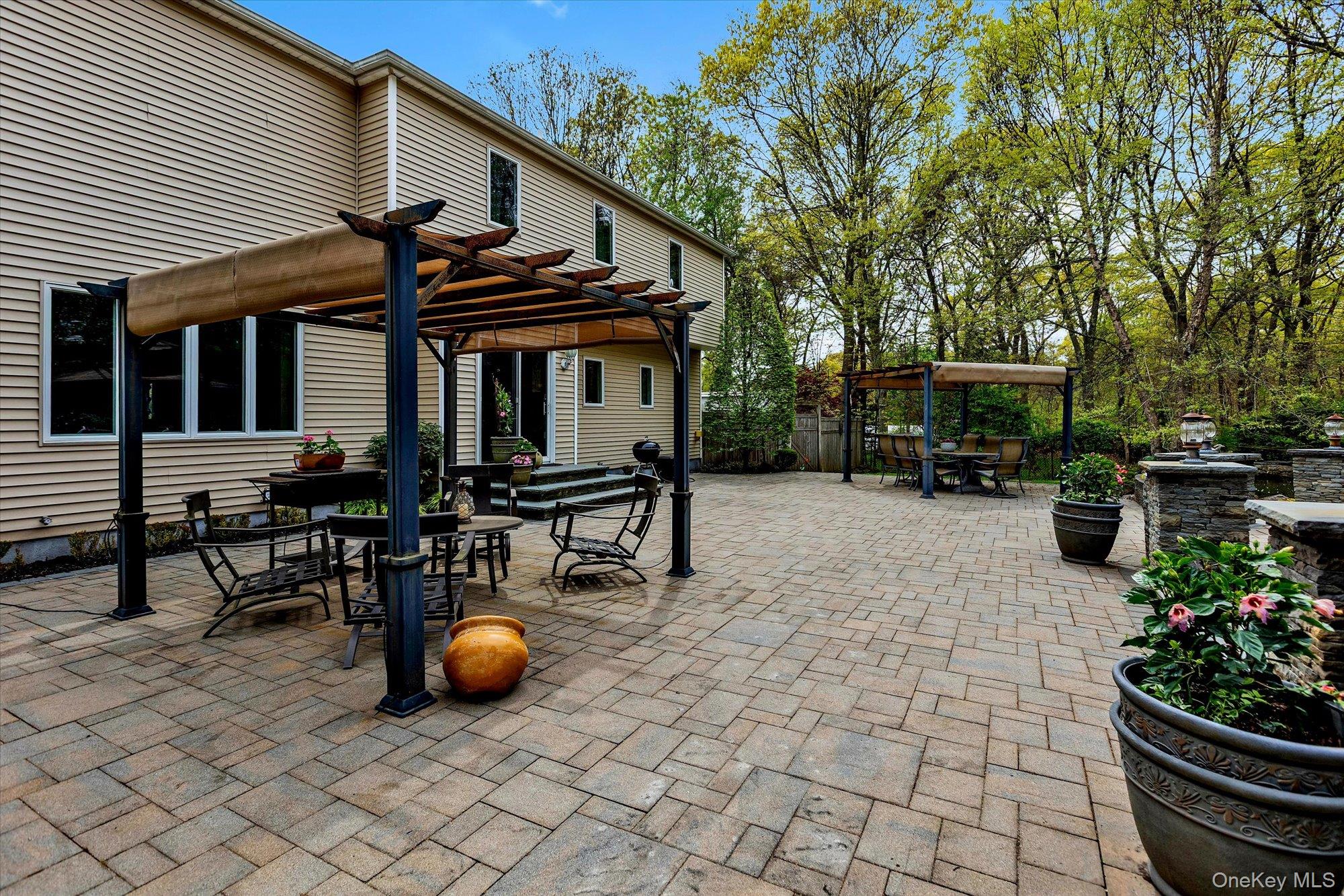 263 Old Commack Road Kings Park, NY 11754 - Photo 29 of 42 a view of a chairs and tables in the back yard of the house