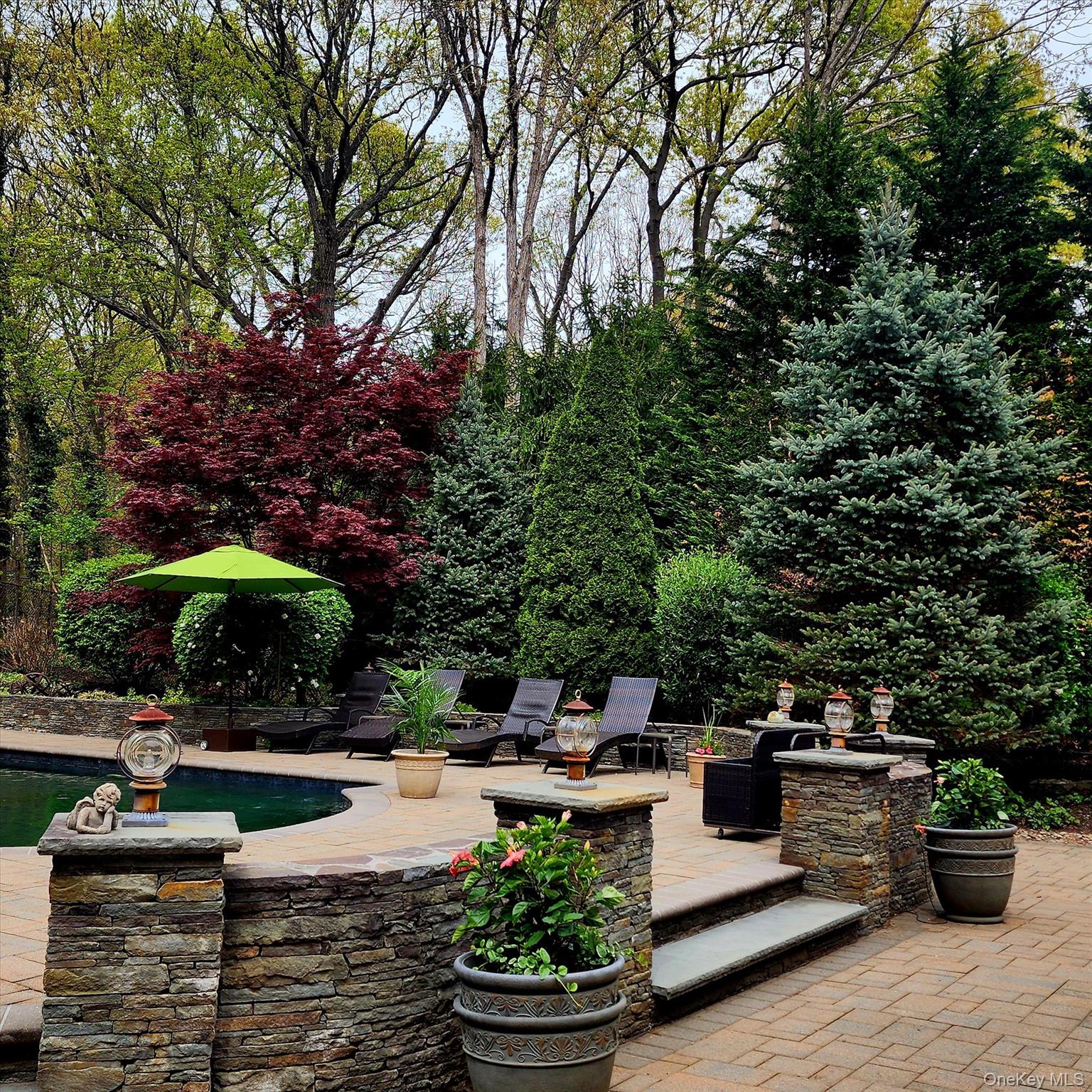 263 Old Commack Road Kings Park, NY 11754 - Photo 30 of 42 a swimming pool with outdoor seating and plants