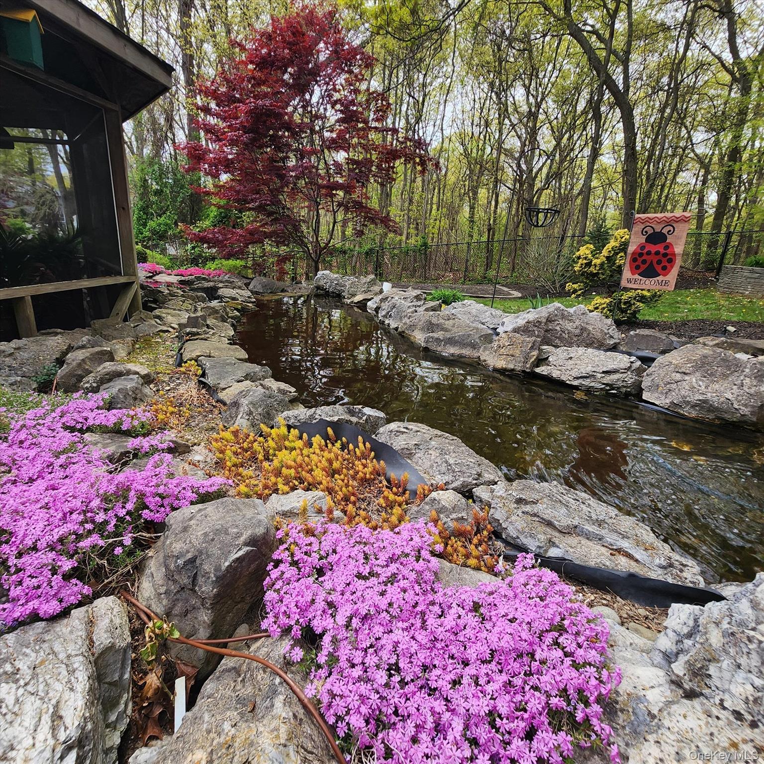 263 Old Commack Road Kings Park, NY 11754 - Photo 39 of 42 a backyard of a house with a yard and fountain