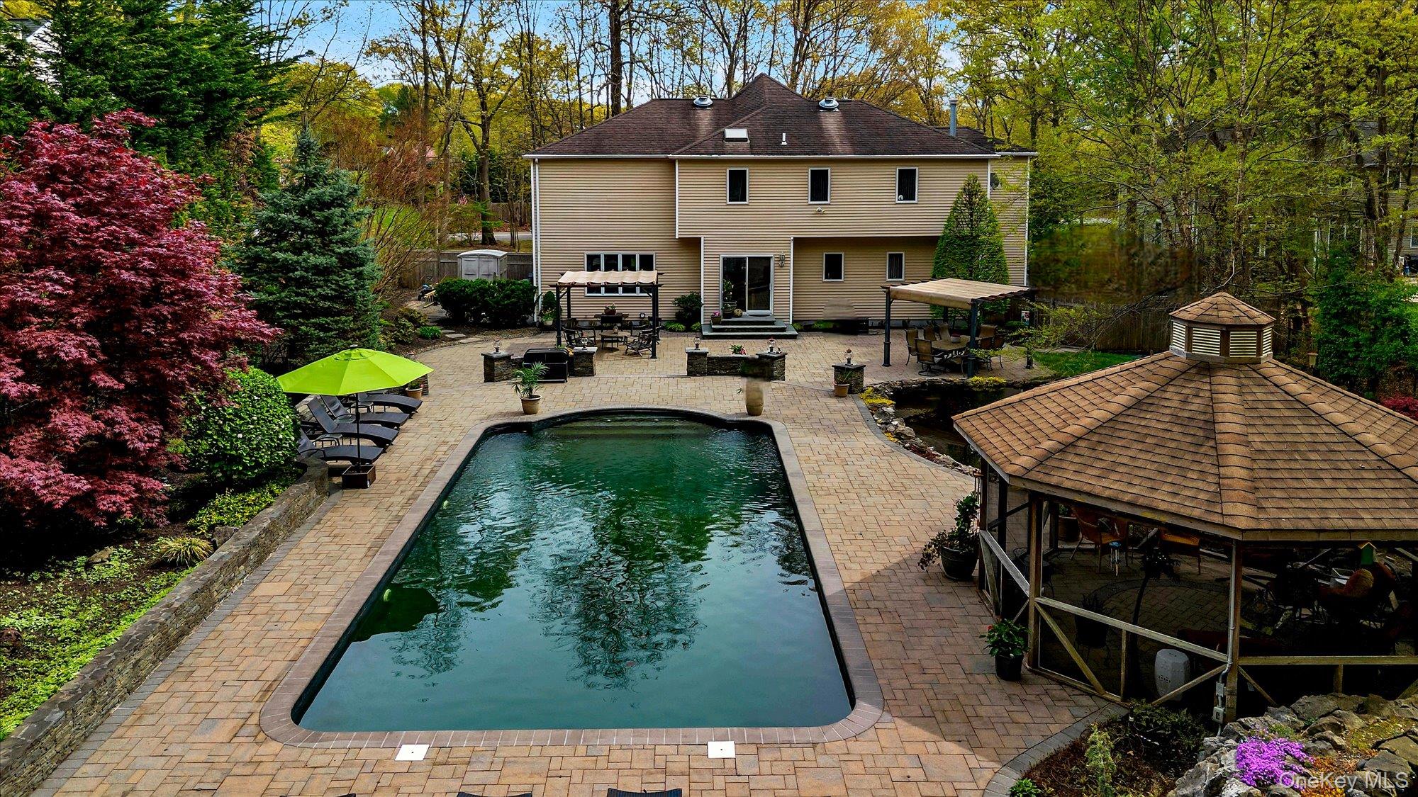 263 Old Commack Road Kings Park, NY 11754 - Photo 40 of 42 swimming pool view with a seating space