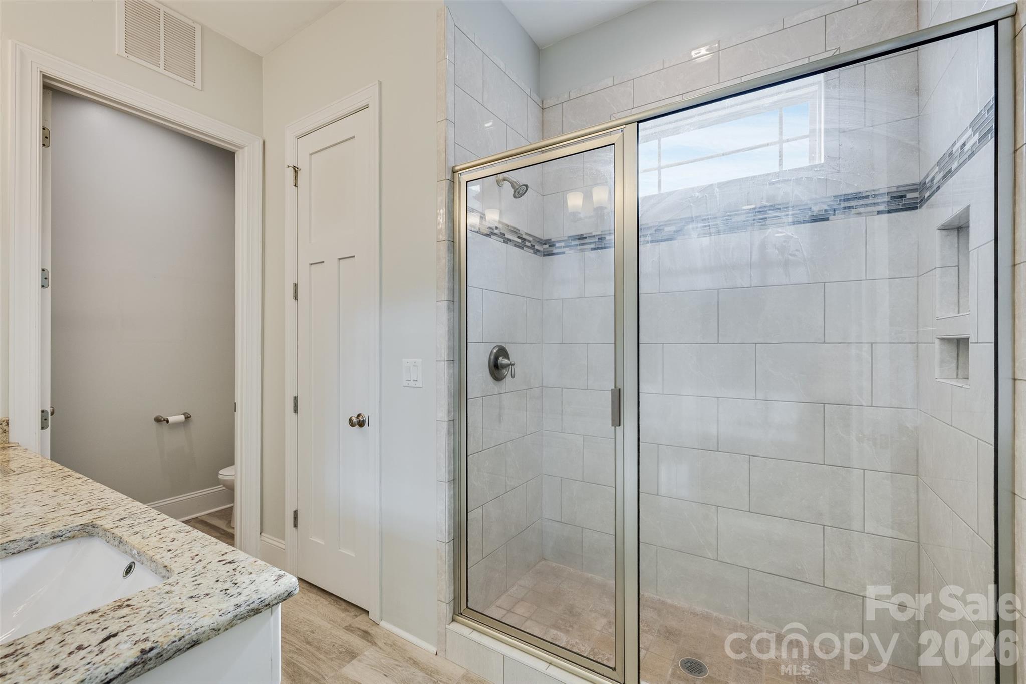 104 Meyers Ridge Road Cramerton, NC 28032 - Photo 10 of 36 a bathroom with a granite countertop shower and a sink