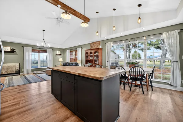 a kitchen with granite countertop a sink stove and cabinets