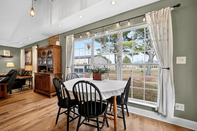a spacious bedroom with a bed a window and a chandelier