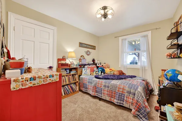 a bed room with a bed and a chandelier