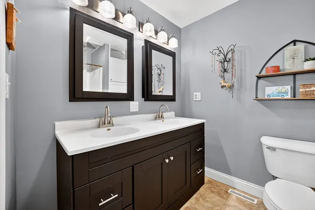 a bathroom with a sink vanity and a mirror