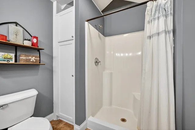 a bathroom with a toilet a sink and mirror