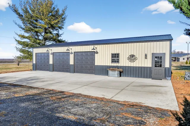 a view of a house with a backyard and a garage