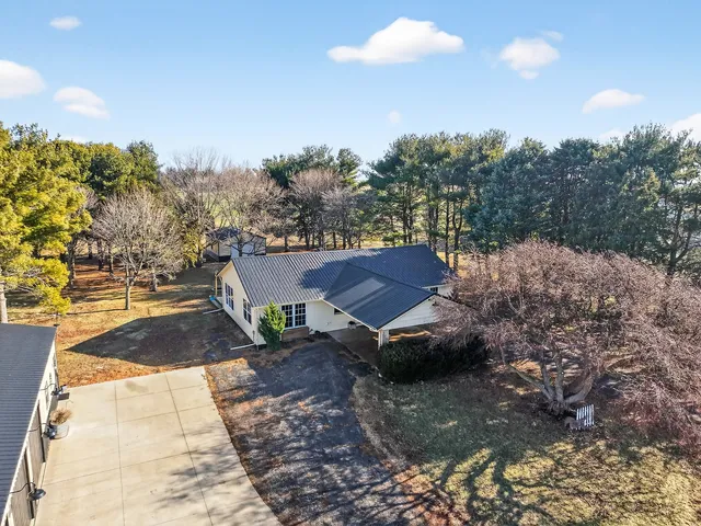 a view of a house with a yard and sitting area
