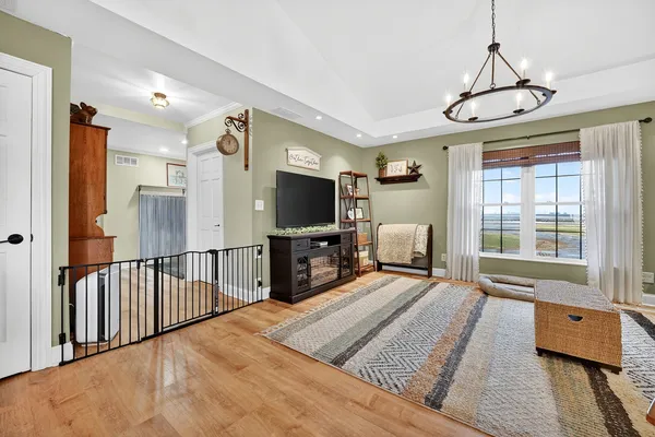 a living room with furniture and a chandelier